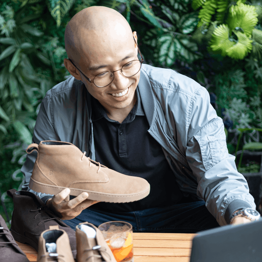 Matt, Birchbury's founder, smiling at home while holding a Birchbury shoe box