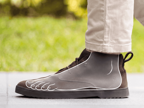 Side profile of a brown suede Birchbury chukka boot with a translucent foot outline overlay, showing the foot sitting flat and level inside the shoe for a natural, zero-drop stance